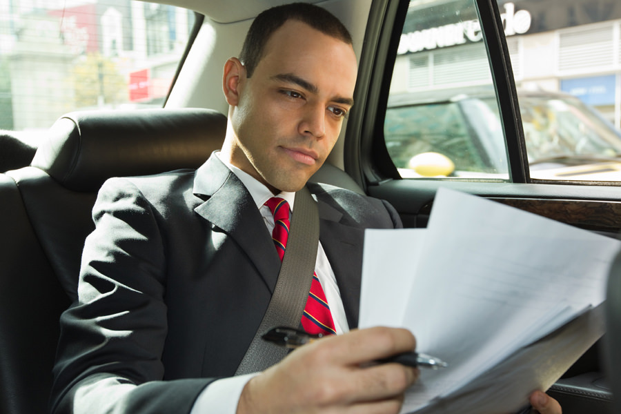 Business Man In Car Going To Meeting